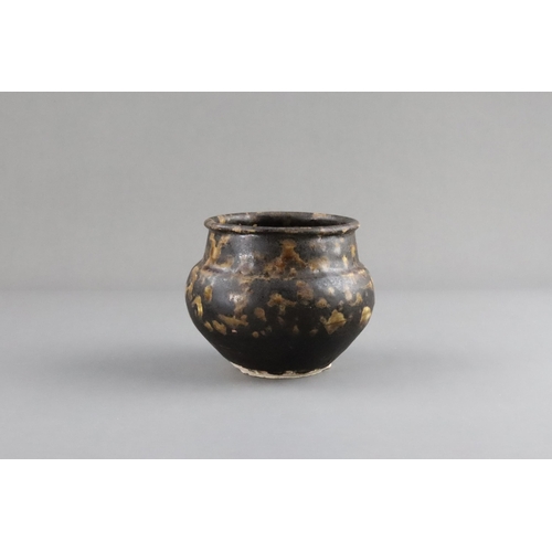 35 - A Jizhou Tortoiseshell Jar, Song dynasty the compressed ovoid body supported on a narrow foot, swell... 