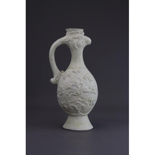 4 - A White-glazed 'Phoenix and Equestrian' Ewer, probably Tang dynasty the finely potted body of ovoid ... 