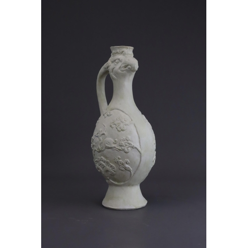 4 - A White-glazed 'Phoenix and Equestrian' Ewer, probably Tang dynasty the finely potted body of ovoid ... 