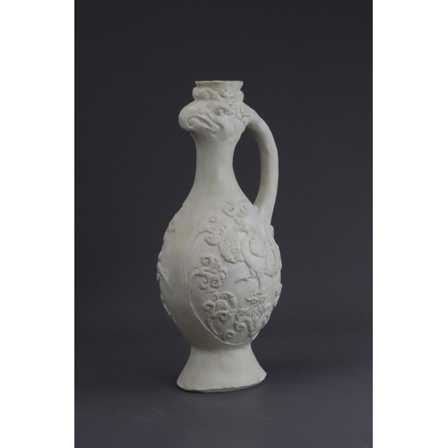 4 - A White-glazed 'Phoenix and Equestrian' Ewer, probably Tang dynasty the finely potted body of ovoid ... 