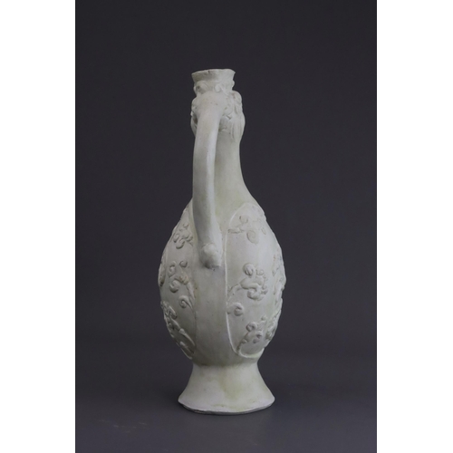 4 - A White-glazed 'Phoenix and Equestrian' Ewer, probably Tang dynasty the finely potted body of ovoid ... 