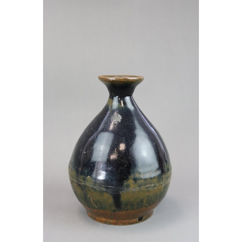 44 - A Black glazed Stoneware Vase, yuhuqunping, Ming dynasty of pear shape, covered with a rich black gl... 