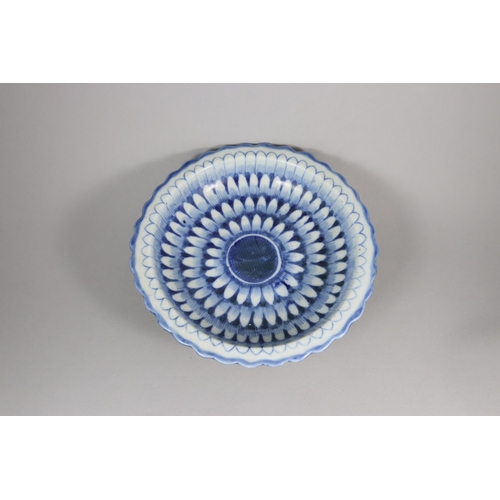 459 - A Blue and White Moulded Dish, 19th century, the interior painted in inky cobalt across the centre, ... 