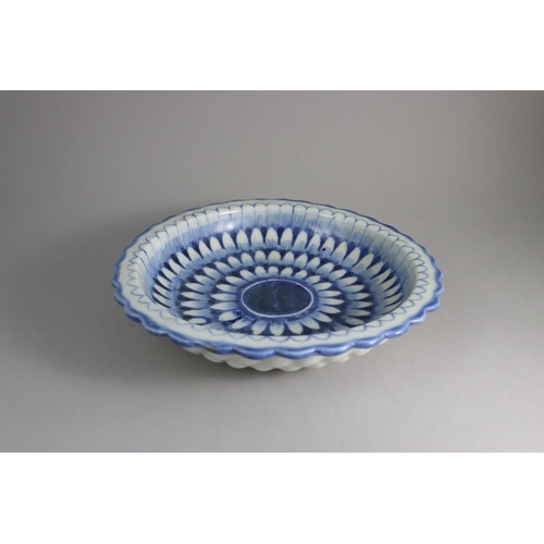 459 - A Blue and White Moulded Dish, 19th century, the interior painted in inky cobalt across the centre, ... 