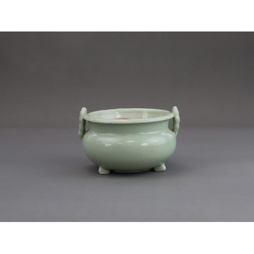 472 - A Celadon Tripod Censer, 18th century, the fine sea green glaze bearing traces of gilding,with strai... 