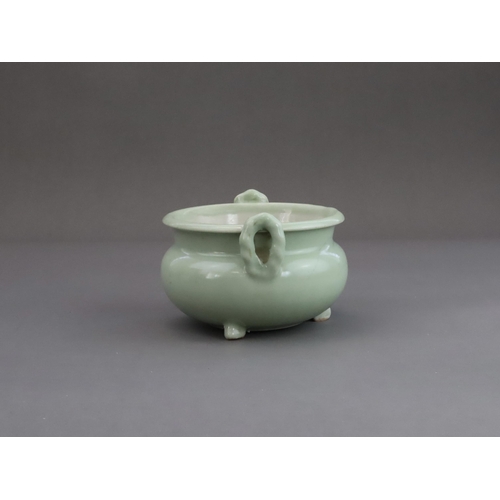 472 - A Celadon Tripod Censer, 18th century, the fine sea green glaze bearing traces of gilding,with strai... 