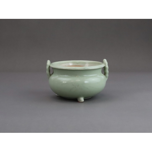 472 - A Celadon Tripod Censer, 18th century, the fine sea green glaze bearing traces of gilding,with strai... 