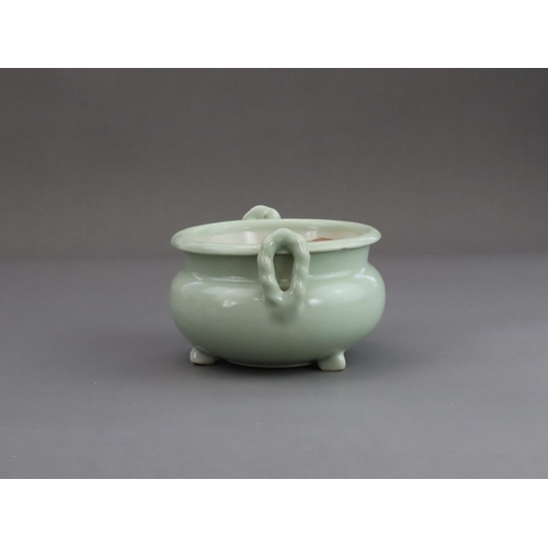 472 - A Celadon Tripod Censer, 18th century, the fine sea green glaze bearing traces of gilding,with strai... 