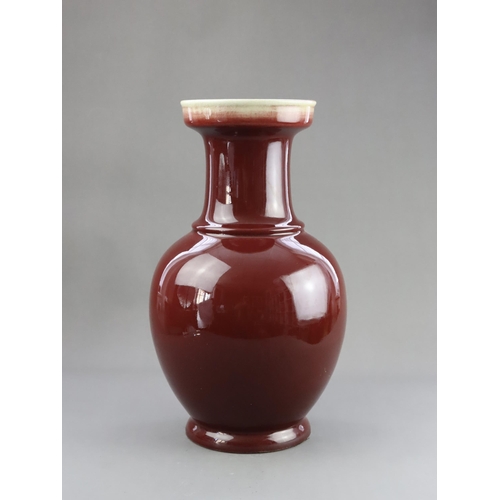 475 - A Red Glazed Vase, 19/20th century, of baluster form with straight neck and galleried rim, covered w... 