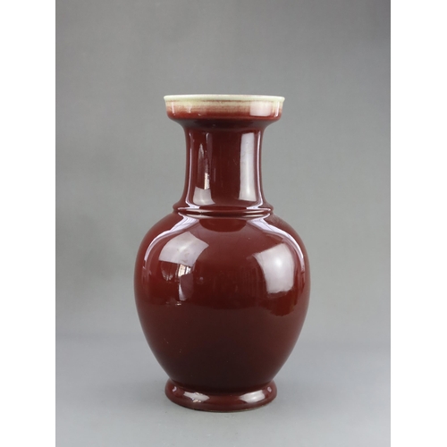 475 - A Red Glazed Vase, 19/20th century, of baluster form with straight neck and galleried rim, covered w... 