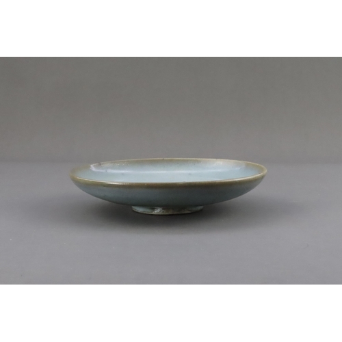 48 - A Jun Blue-glazed Dish, Jin dynasty the gently rounded sides rising from a short recessed foot, cove... 