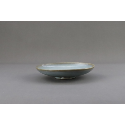 48 - A Jun Blue-glazed Dish, Jin dynasty the gently rounded sides rising from a short recessed foot, cove... 