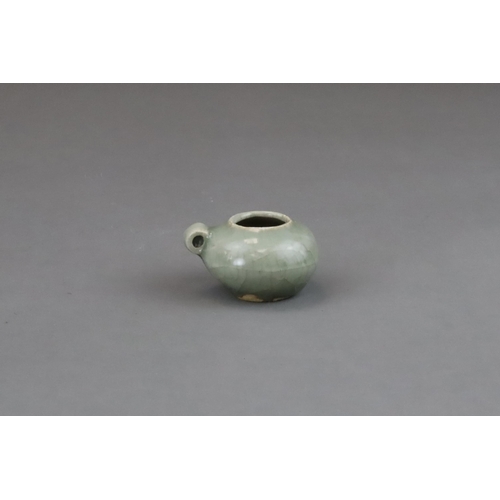 49 - A Longquan Celadon Bird Feeder, Song dynasty of compressed globular form, set with a ring handle at ... 