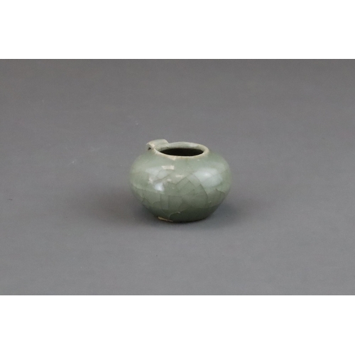 49 - A Longquan Celadon Bird Feeder, Song dynasty of compressed globular form, set with a ring handle at ... 