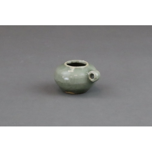 49 - A Longquan Celadon Bird Feeder, Song dynasty of compressed globular form, set with a ring handle at ... 