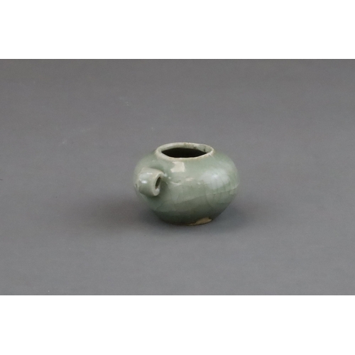 49 - A Longquan Celadon Bird Feeder, Song dynasty of compressed globular form, set with a ring handle at ... 