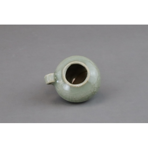 49 - A Longquan Celadon Bird Feeder, Song dynasty of compressed globular form, set with a ring handle at ... 