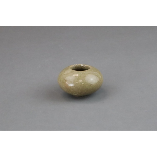 50 - A Longquan Yellow-glazed Bird Feeder, Song dynasty of compressed globular form, with ring handle at ... 