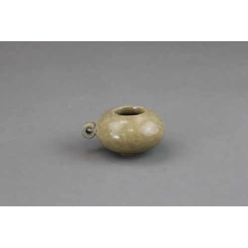 50 - A Longquan Yellow-glazed Bird Feeder, Song dynasty of compressed globular form, with ring handle at ... 