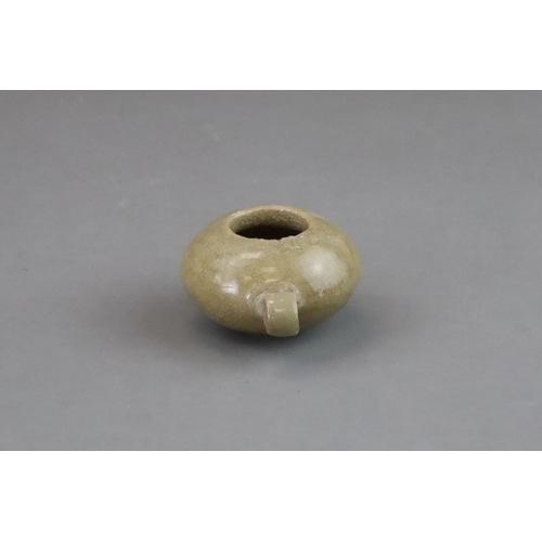 50 - A Longquan Yellow-glazed Bird Feeder, Song dynasty of compressed globular form, with ring handle at ... 