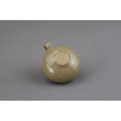 50 - A Longquan Yellow-glazed Bird Feeder, Song dynasty of compressed globular form, with ring handle at ... 