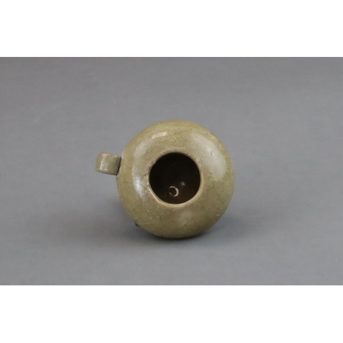 50 - A Longquan Yellow-glazed Bird Feeder, Song dynasty of compressed globular form, with ring handle at ... 