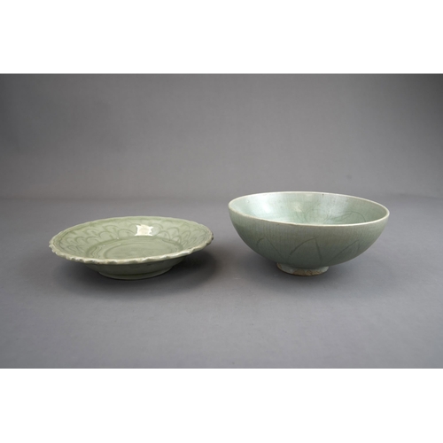 51 - A Carved Celadon Dish and Bowl, Song dynasty and later bowl of rounded shape, carved lotus petals on... 