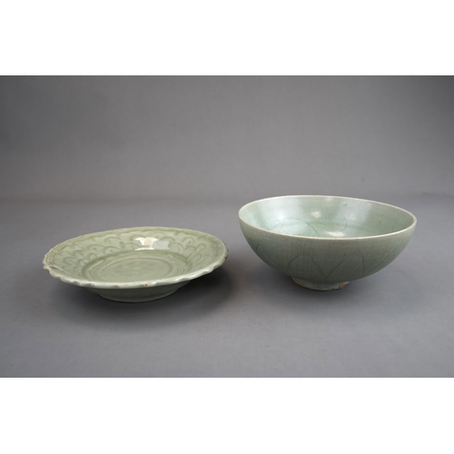 51 - A Carved Celadon Dish and Bowl, Song dynasty and later bowl of rounded shape, carved lotus petals on... 