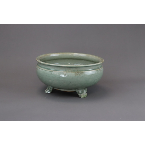 52 - A Longquan Celadon Tripod Incense Burner, Ming dynasty raised on three splayed monster mask feet, ca... 