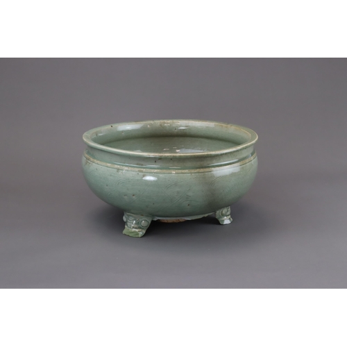 52 - A Longquan Celadon Tripod Incense Burner, Ming dynasty raised on three splayed monster mask feet, ca... 