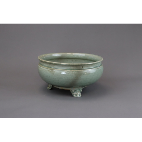 52 - A Longquan Celadon Tripod Incense Burner, Ming dynasty raised on three splayed monster mask feet, ca... 