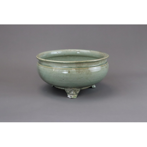 52 - A Longquan Celadon Tripod Incense Burner, Ming dynasty raised on three splayed monster mask feet, ca... 