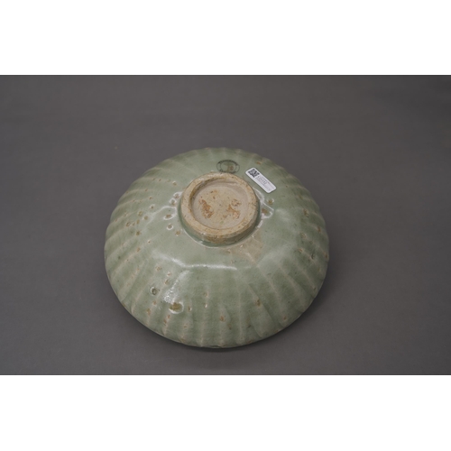 53 - A Longquan Celadon Lotus Bowl, Song dynasty the robustly-potted deep rounded sides rising from a nar... 