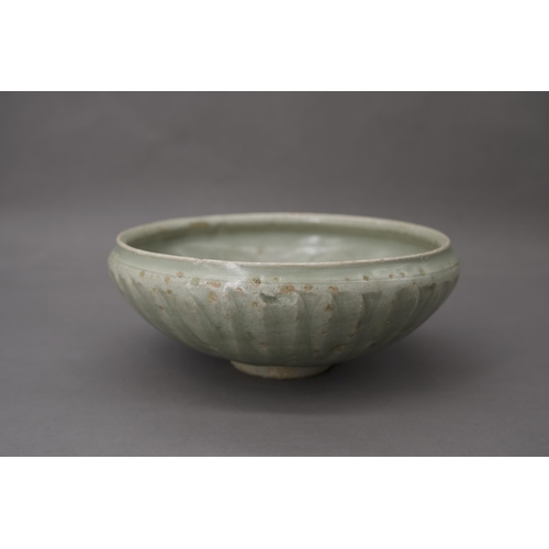 53 - A Longquan Celadon Lotus Bowl, Song dynasty the robustly-potted deep rounded sides rising from a nar... 