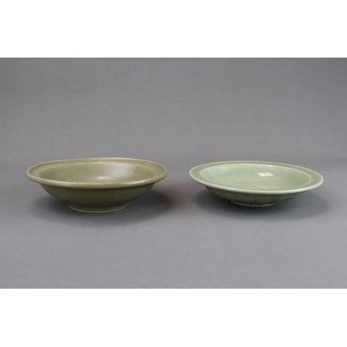 54 - Two Longquan Celadon Dishes, Song dynasty one with short foot and everted rim, with carved lotus out... 