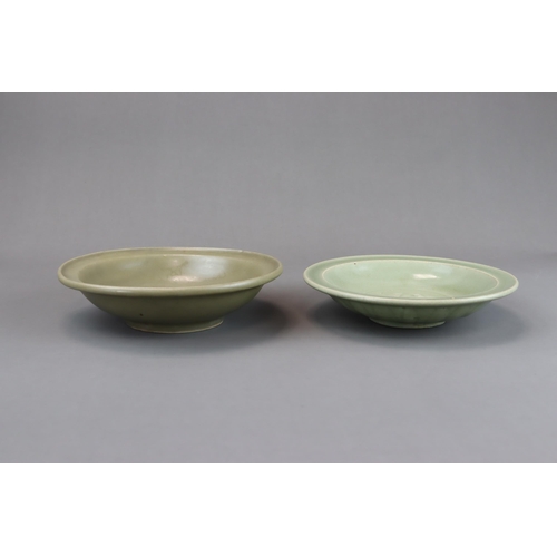 54 - Two Longquan Celadon Dishes, Song dynasty one with short foot and everted rim, with carved lotus out... 