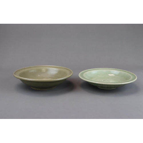 54 - Two Longquan Celadon Dishes, Song dynasty one with short foot and everted rim, with carved lotus out... 