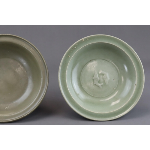 54 - Two Longquan Celadon Dishes, Song dynasty one with short foot and everted rim, with carved lotus out... 