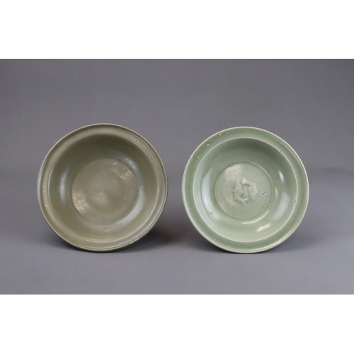 54 - Two Longquan Celadon Dishes, Song dynasty one with short foot and everted rim, with carved lotus out... 