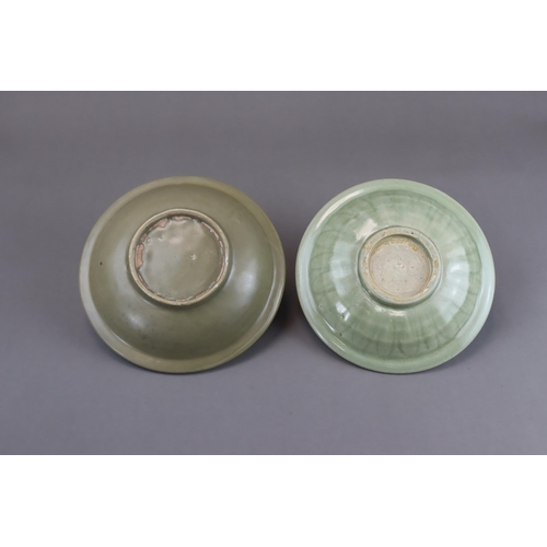 54 - Two Longquan Celadon Dishes, Song dynasty one with short foot and everted rim, with carved lotus out... 