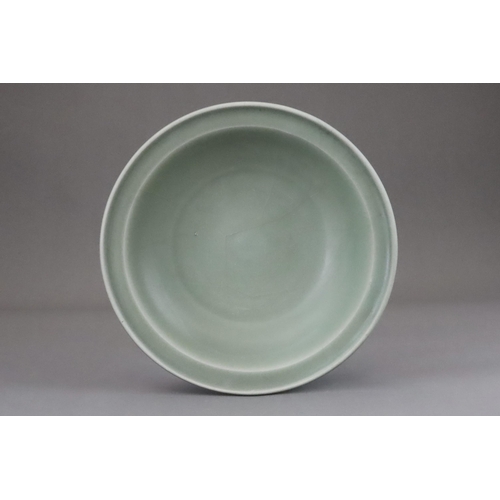 55 - A Longquan Celadon Dish, Song dynasty the shallow rounded sides rising from a short foot to an evert... 