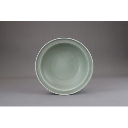 55 - A Longquan Celadon Dish, Song dynasty the shallow rounded sides rising from a short foot to an evert... 