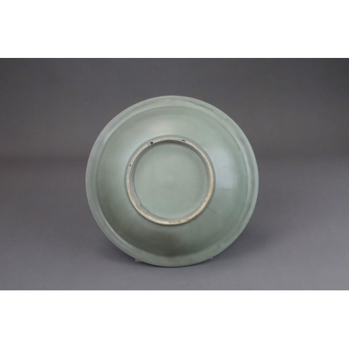 55 - A Longquan Celadon Dish, Song dynasty the shallow rounded sides rising from a short foot to an evert... 