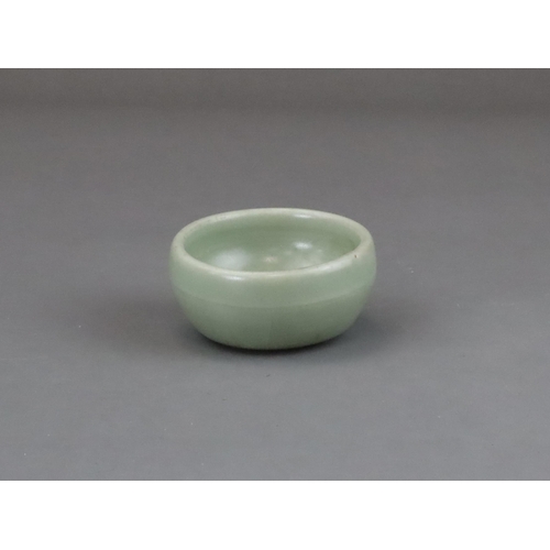 56 - A Longquan Celadon Cup, Yuan dynasty of rounded shape from the short foot, the exterior with a raise... 