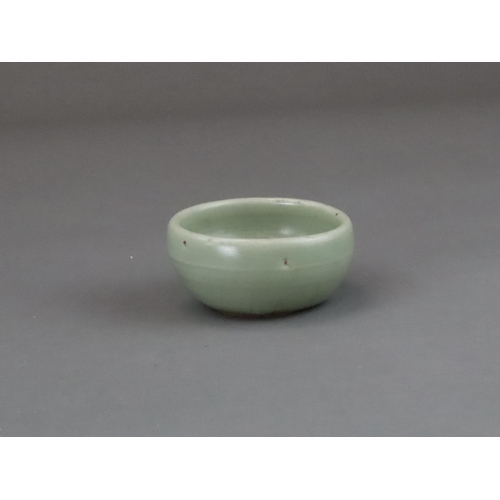 56 - A Longquan Celadon Cup, Yuan dynasty of rounded shape from the short foot, the exterior with a raise... 