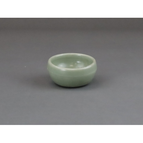 56 - A Longquan Celadon Cup, Yuan dynasty of rounded shape from the short foot, the exterior with a raise... 