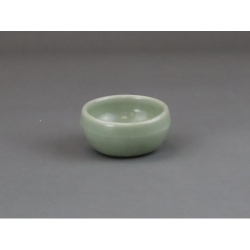 56 - A Longquan Celadon Cup, Yuan dynasty of rounded shape from the short foot, the exterior with a raise... 