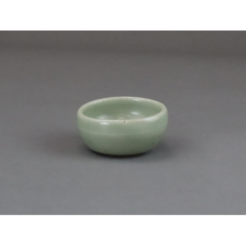 56 - A Longquan Celadon Cup, Yuan dynasty of rounded shape from the short foot, the exterior with a raise... 