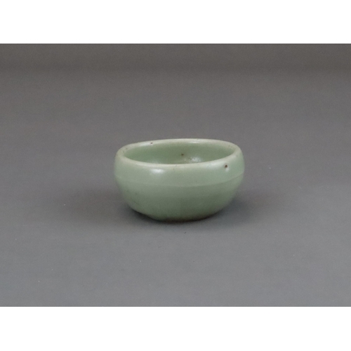 56 - A Longquan Celadon Cup, Yuan dynasty of rounded shape from the short foot, the exterior with a raise... 