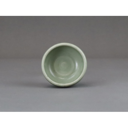 56 - A Longquan Celadon Cup, Yuan dynasty of rounded shape from the short foot, the exterior with a raise... 